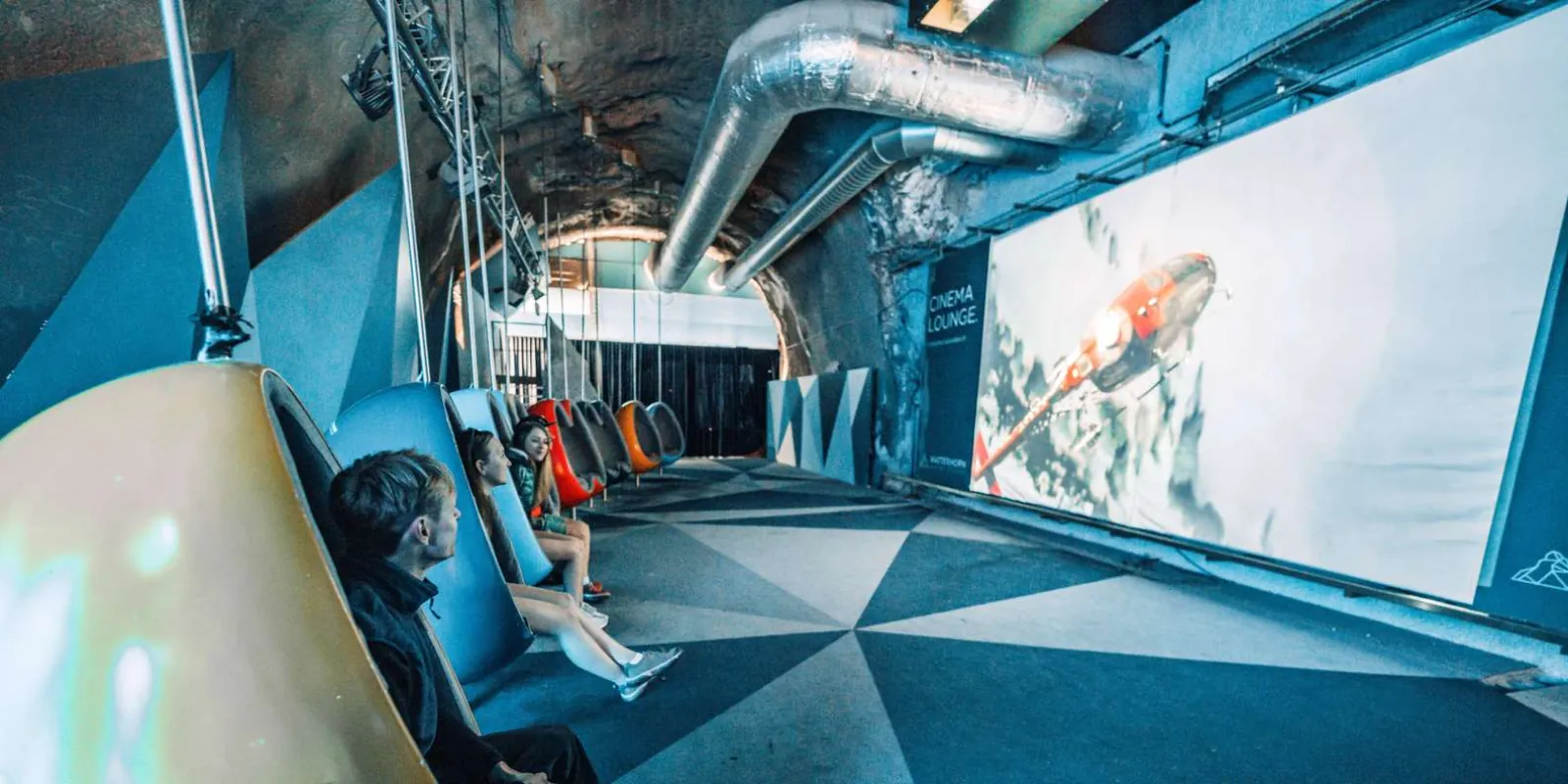 The cinema lounge inside the Matterhorn Glacier Paradise summit station, with suspended pod seating